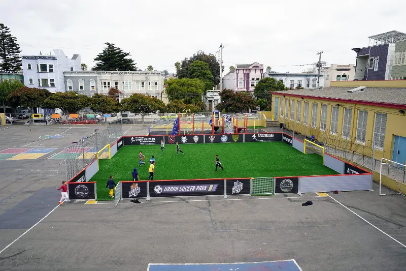 Kids playing on a mini-pitch in a schoolyard in San Francisco